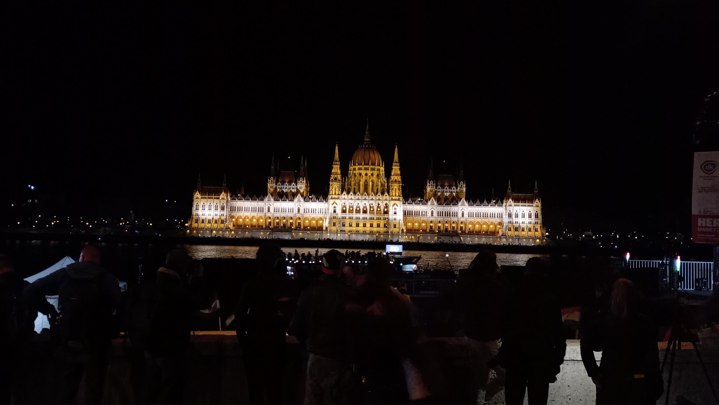 Budapest's parliament lit up beside the Danube at night
